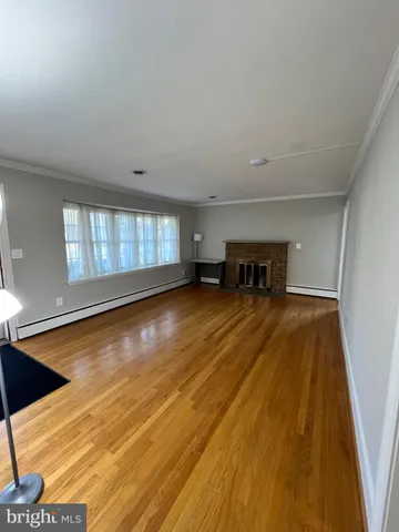 a view of empty room with a window and fireplace