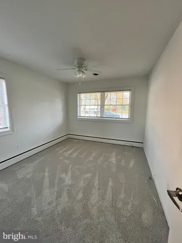 an empty room with a empty space and windows