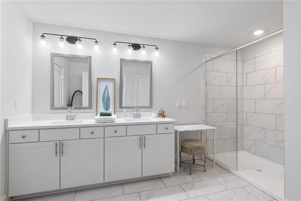 3334 Swallowtail Terrace Duluth, GA 30096 - Photo 13 of 30 a bathroom with a double vanity sink and a mirror