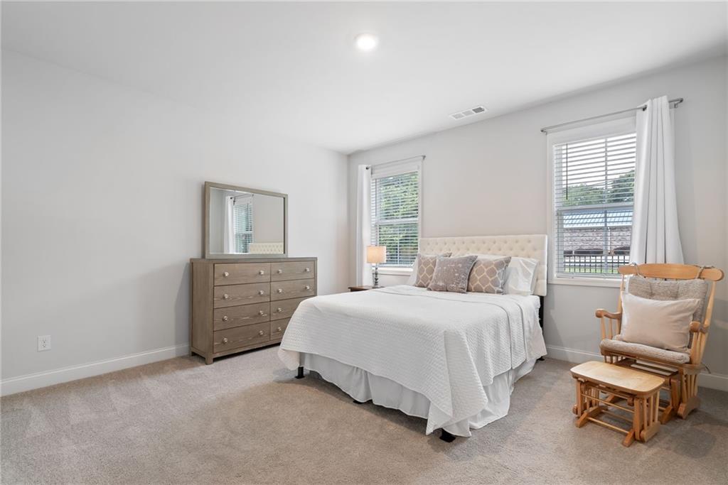 3334 Swallowtail Terrace Duluth, GA 30096 - Photo 17 of 30 a spacious bedroom with a bed and a window