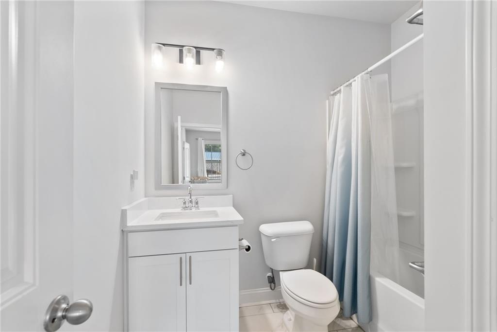 3334 Swallowtail Terrace Duluth, GA 30096 - Photo 18 of 30 a bathroom with a sink vanity mirror and toilet
