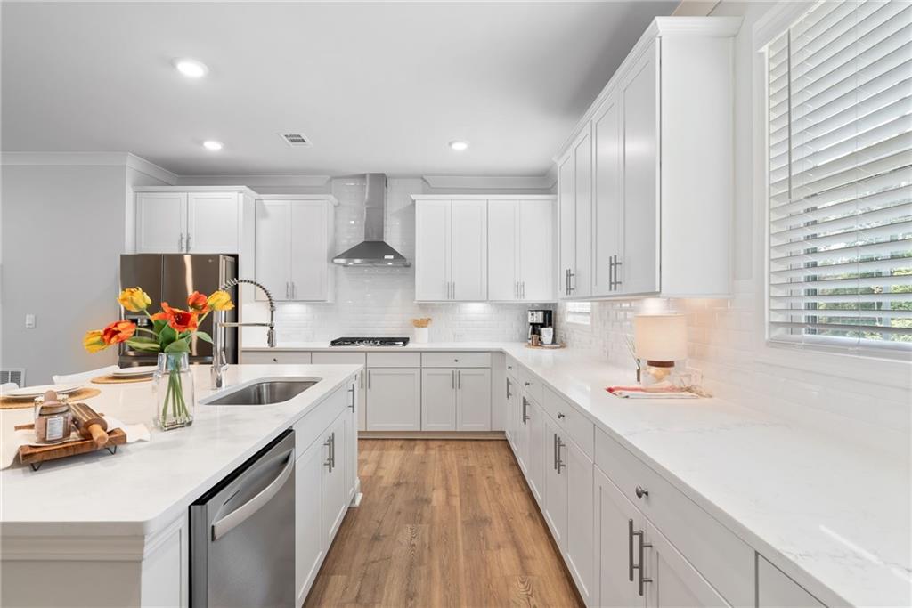 3334 Swallowtail Terrace Duluth, GA 30096 - Photo 18 of 27 a kitchen with a sink stove top oven and cabinets