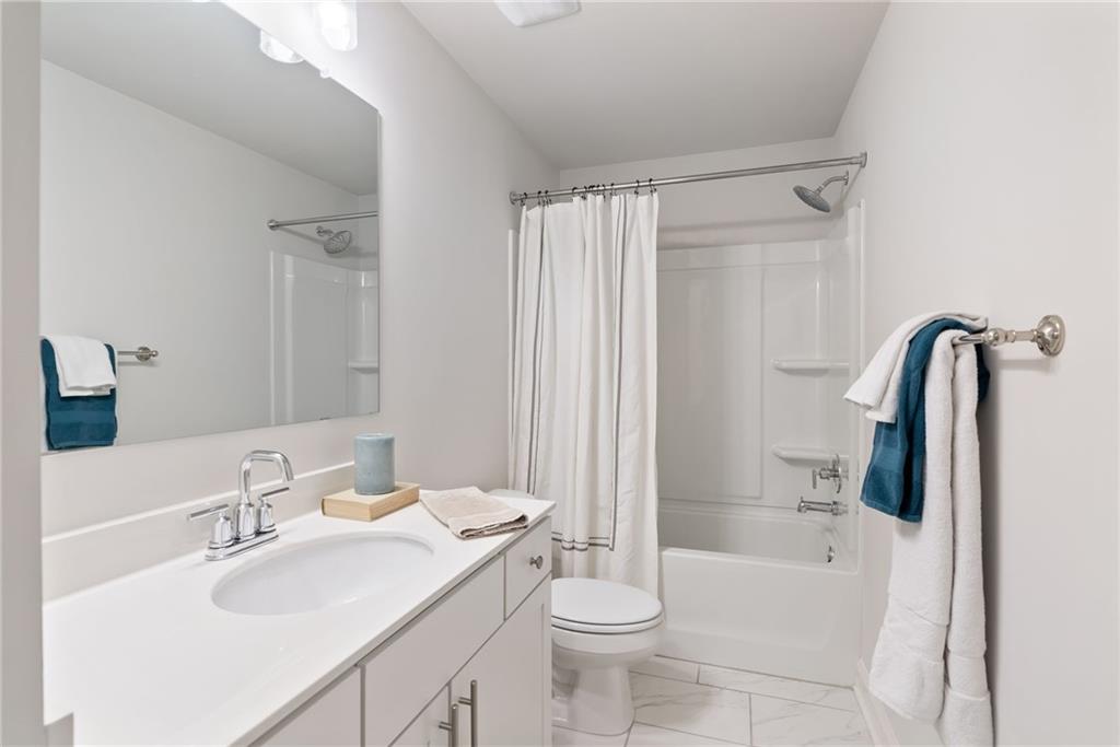 3334 Swallowtail Terrace Duluth, GA 30096 - Photo 23 of 30 a bathroom with a sink toilet and shower
