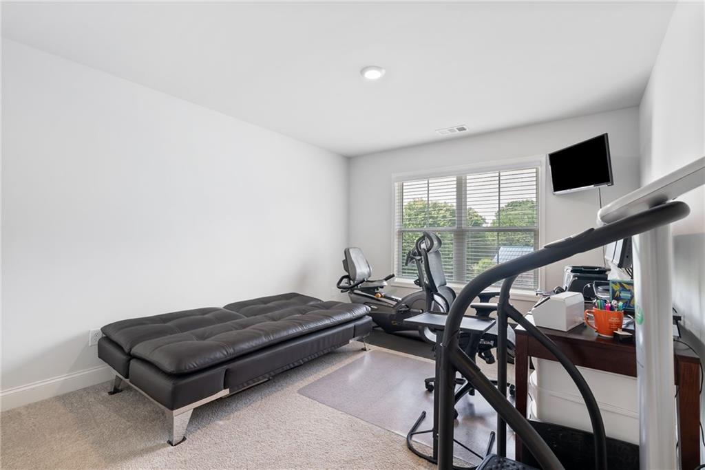 3334 Swallowtail Terrace Duluth, GA 30096 - Photo 25 of 30 a living room with furniture and a flat screen tv