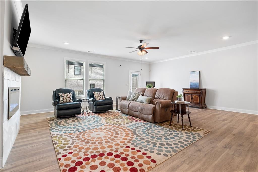 3334 Swallowtail Terrace Duluth, GA 30096 - Photo 6 of 30 a living room with furniture or couch and a flat screen tv