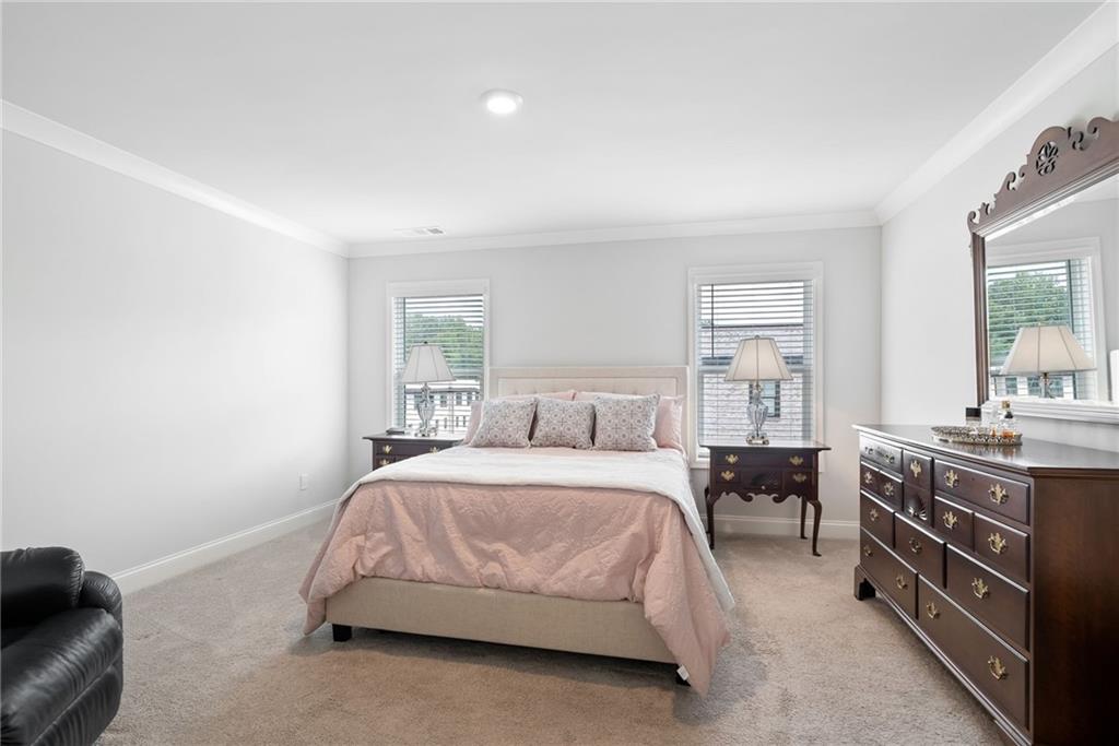3334 Swallowtail Terrace Duluth, GA 30096 - Photo 7 of 27 a bedroom with a bed and a dresser