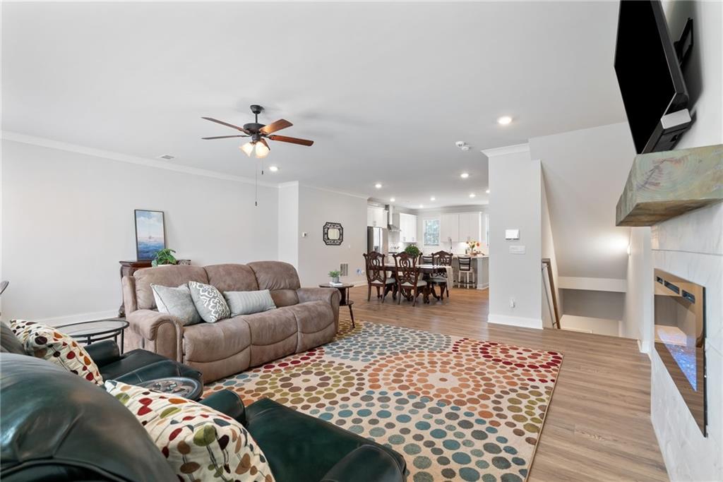 3334 Swallowtail Terrace Duluth, GA 30096 - Photo 7 of 30 a living room with furniture and a fireplace