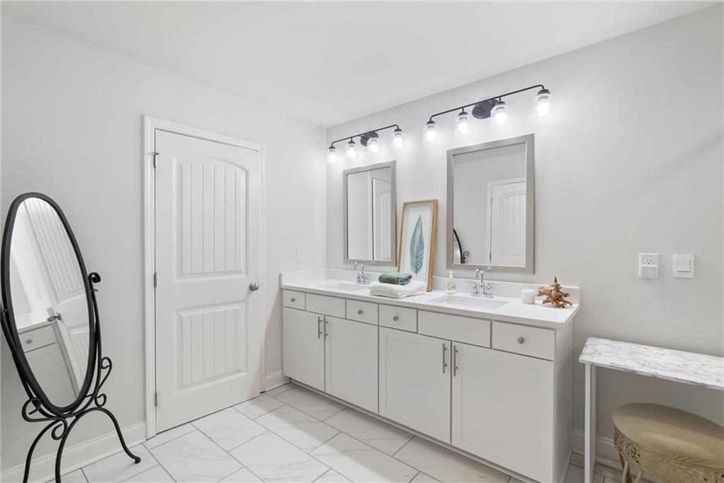 3334 Swallowtail Terrace Duluth, GA 30096 - Photo 8 of 27 a bathroom with a double vanity sink mirror and