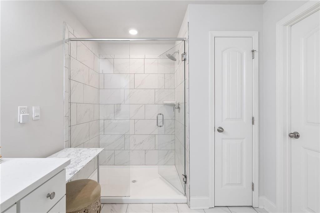 3334 Swallowtail Terrace Duluth, GA 30096 - Photo 9 of 27 a bathroom with a shower and bathtub