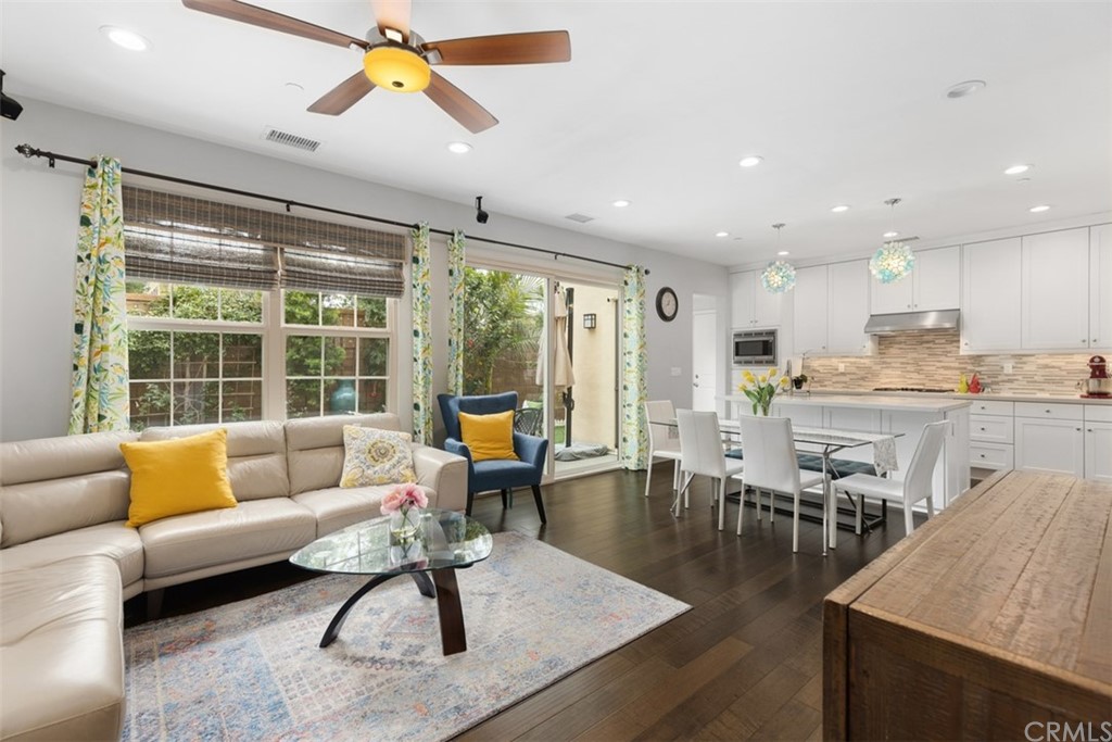 a living room with furniture and kitchen view