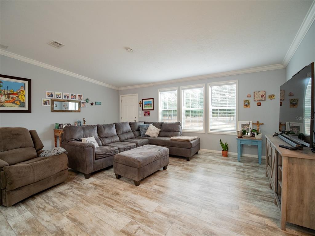 5431 163rd Path Live Oak, FL 32060 - Photo 15 of 49 a living room with furniture flat screen tv and large windows