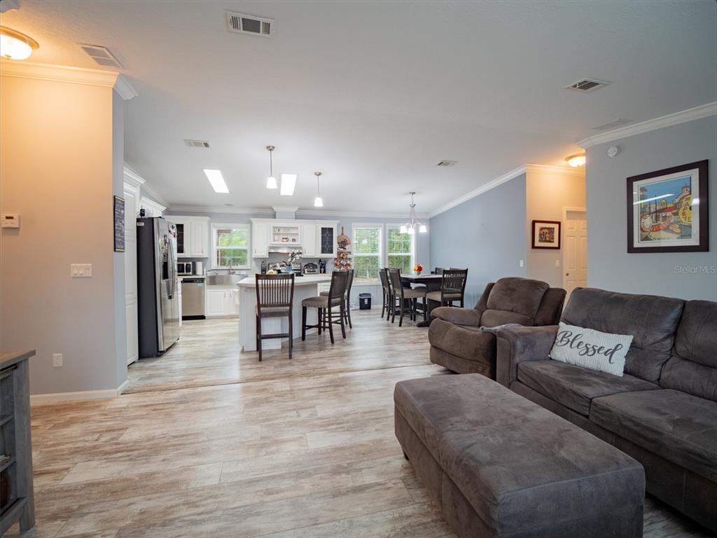5431 163rd Path Live Oak, FL 32060 - Photo 17 of 49 a living room with furniture and kitchen view with wooden floor