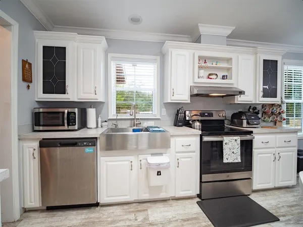 a kitchen with stainless steel appliances granite countertop a refrigerator sink and cabinets