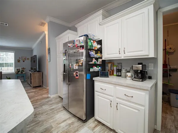 a large kitchen with a table and chairs