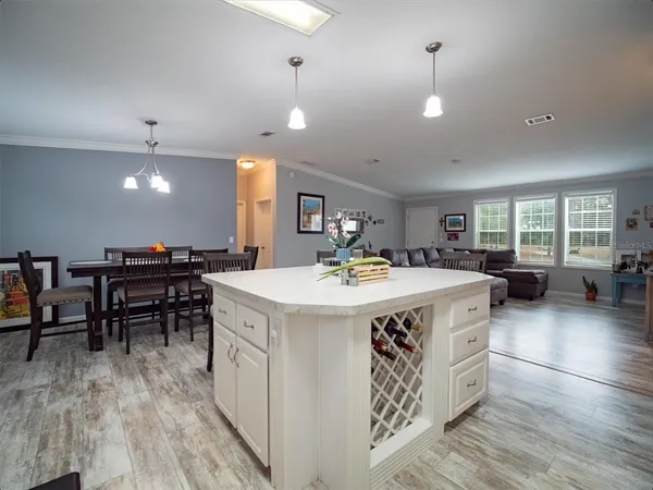 a dining room with furniture and wooden floor