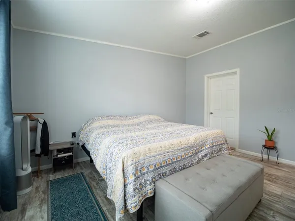 a bedroom with a bed and a television