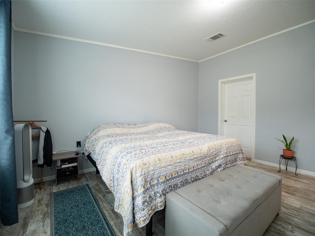 5431 163rd Path Live Oak, FL 32060 - Photo 27 of 49 a bedroom with a bed and a mirror
