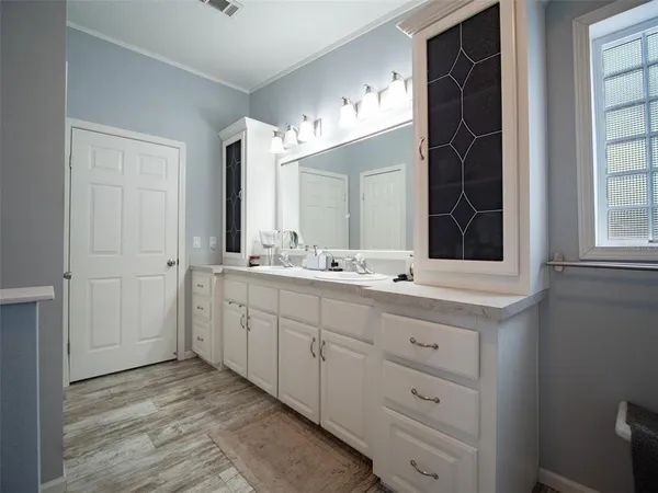 a bathroom with a double vanity sink a and a mirror