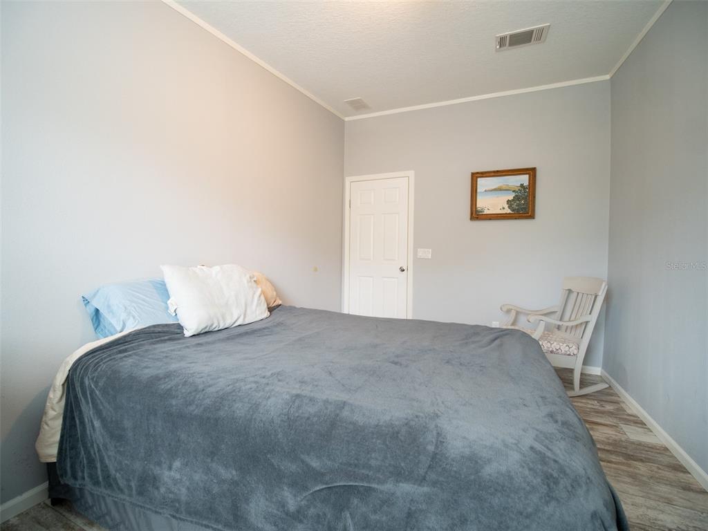5431 163rd Path Live Oak, FL 32060 - Photo 35 of 49 a bedroom with a bed and chair