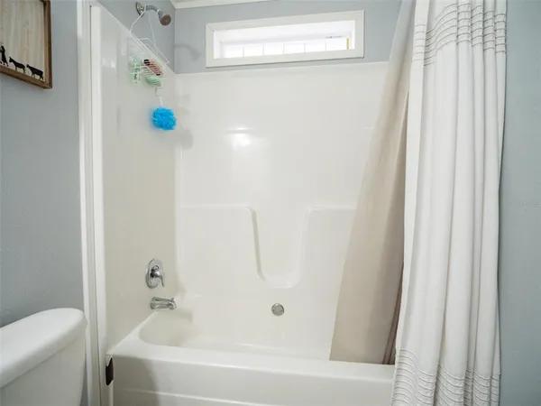 a bathroom with a toilet a sink a mirror and vanity