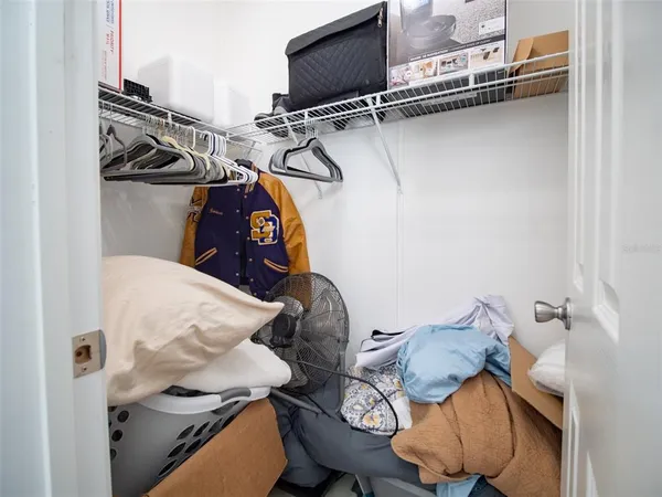 a utility room with dryer washer and shoe rack