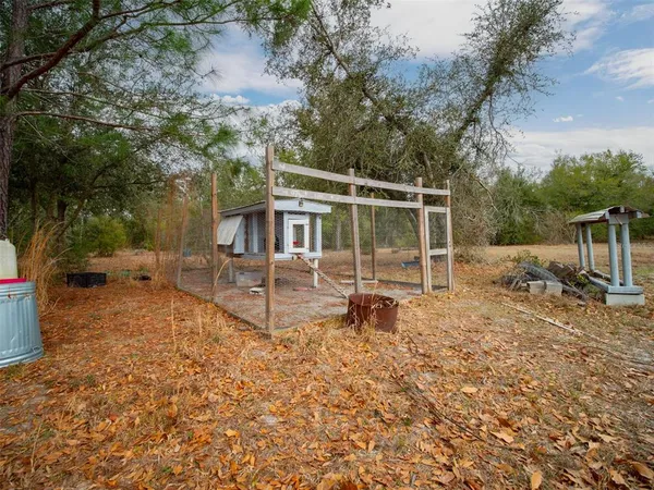 a backyard of a house with fire pit and trees