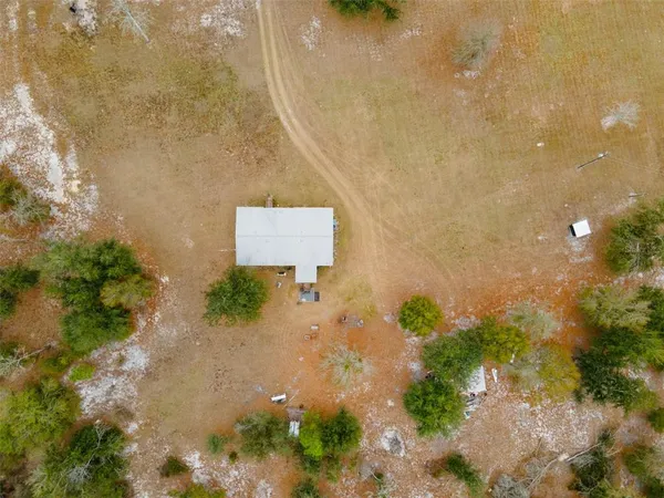 an aerial view of ocean with yard