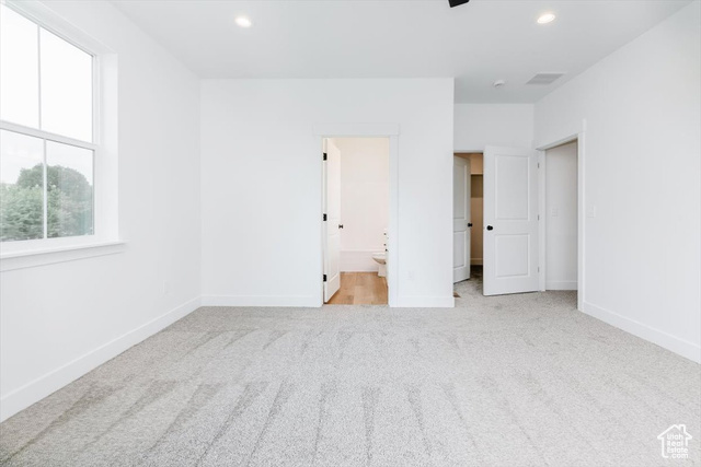 195 West 300 North Logan, UT 84321 - Photo 13 of 20 Unfurnished bedroom featuring light colored carpet, ensuite bathroom, recessed lighting, and ceiling fan