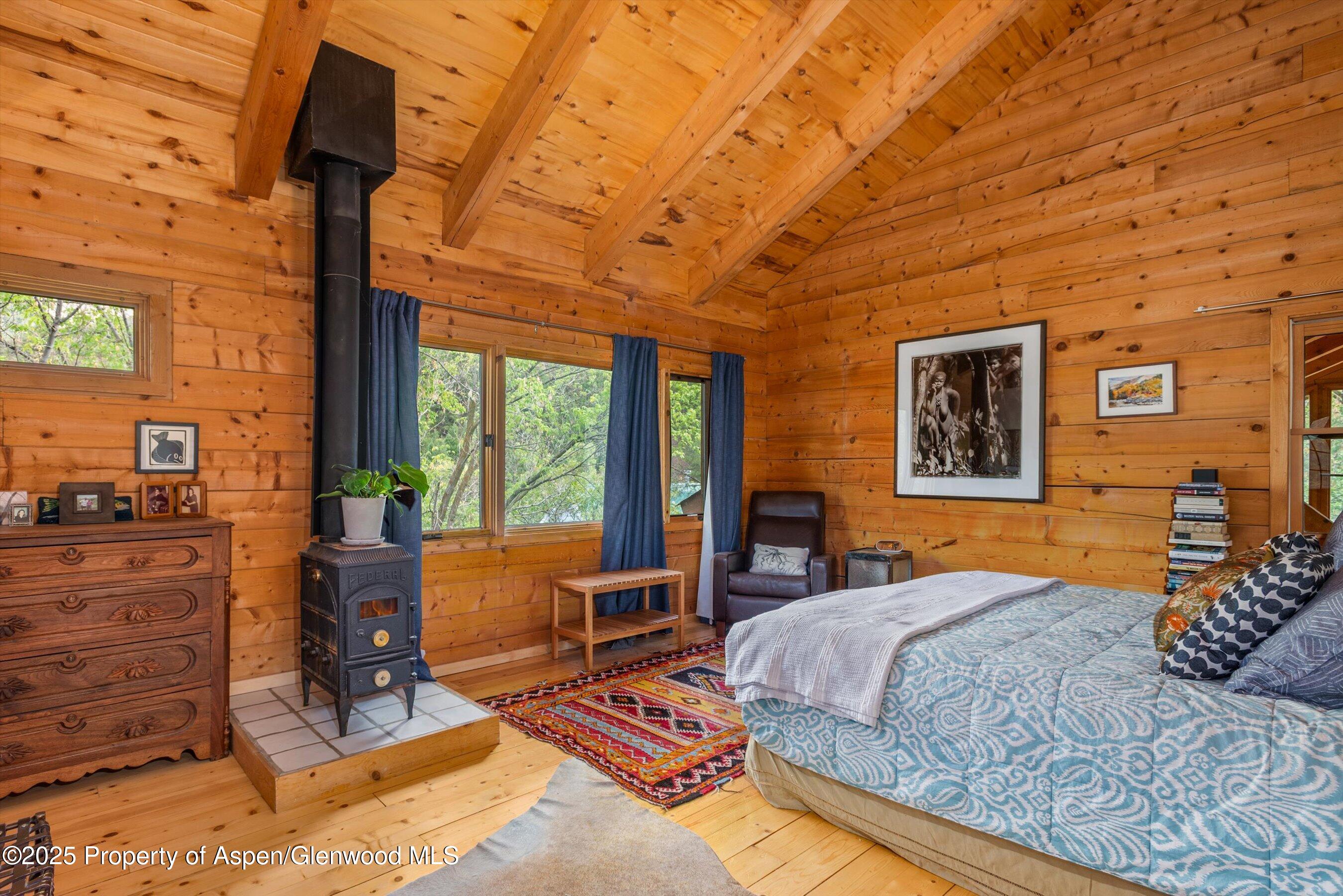 166 Ute Trail Carbondale, CO 81623 - Photo 25 of 38 a bedroom with a bed and wooden floor