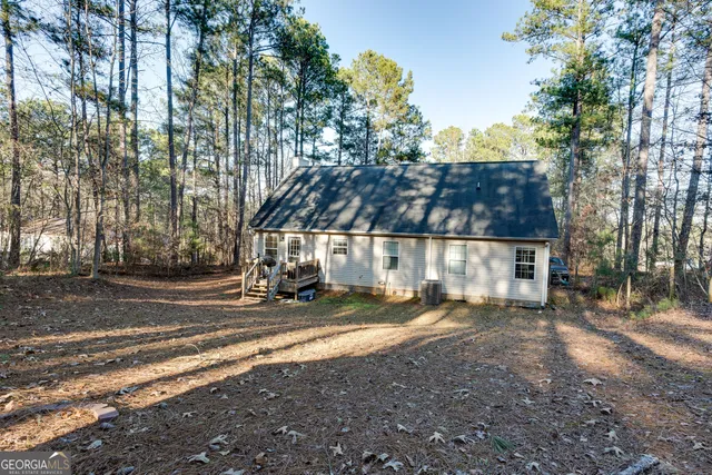 a view of a house with a yard and tree s