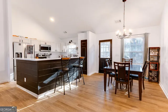 a view of a dining room with furniture and wooden floor