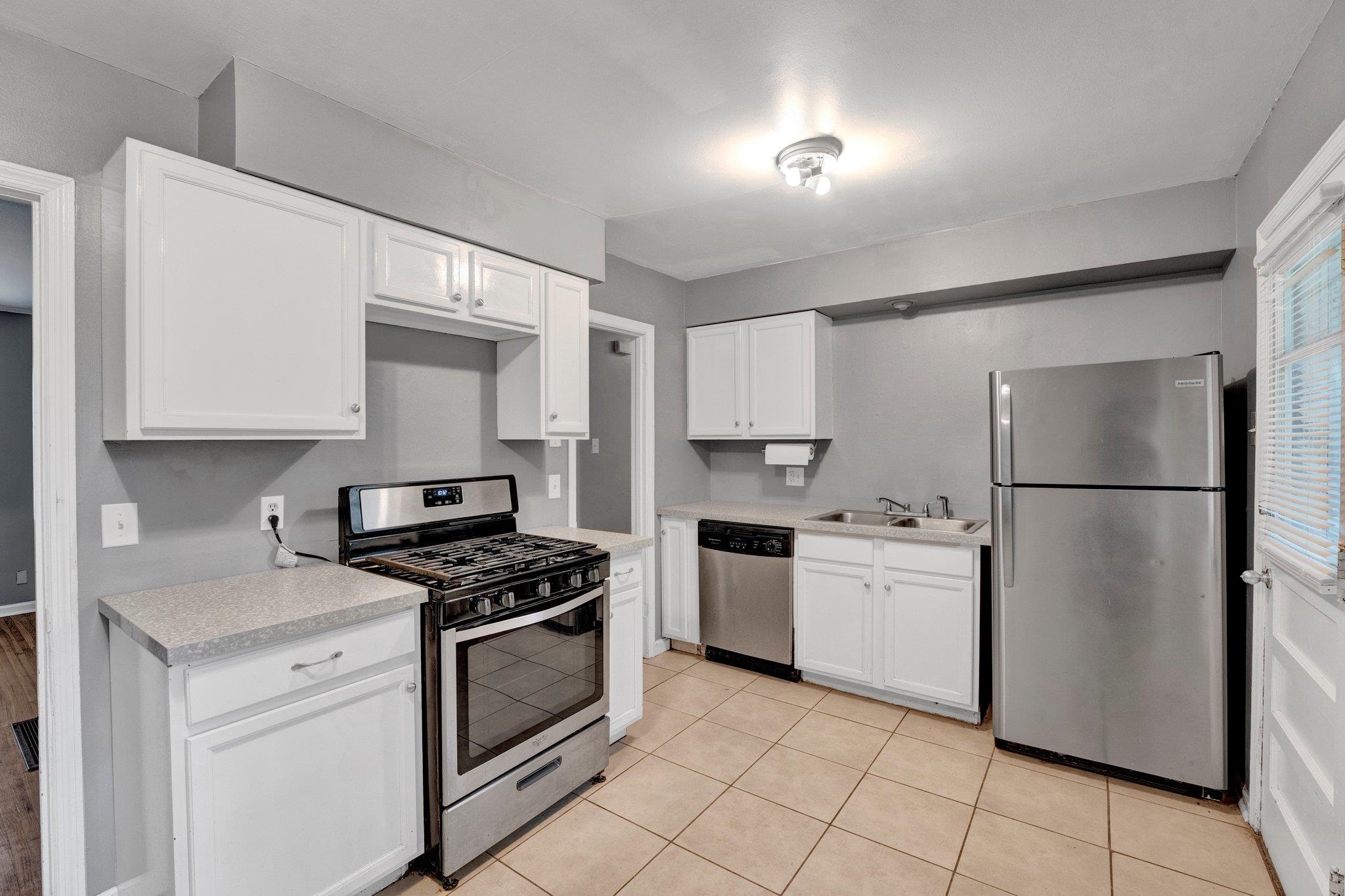 985 Wellsville Road Memphis, TN 38117 - Photo 20 of 24 a kitchen with white cabinets and white appliances