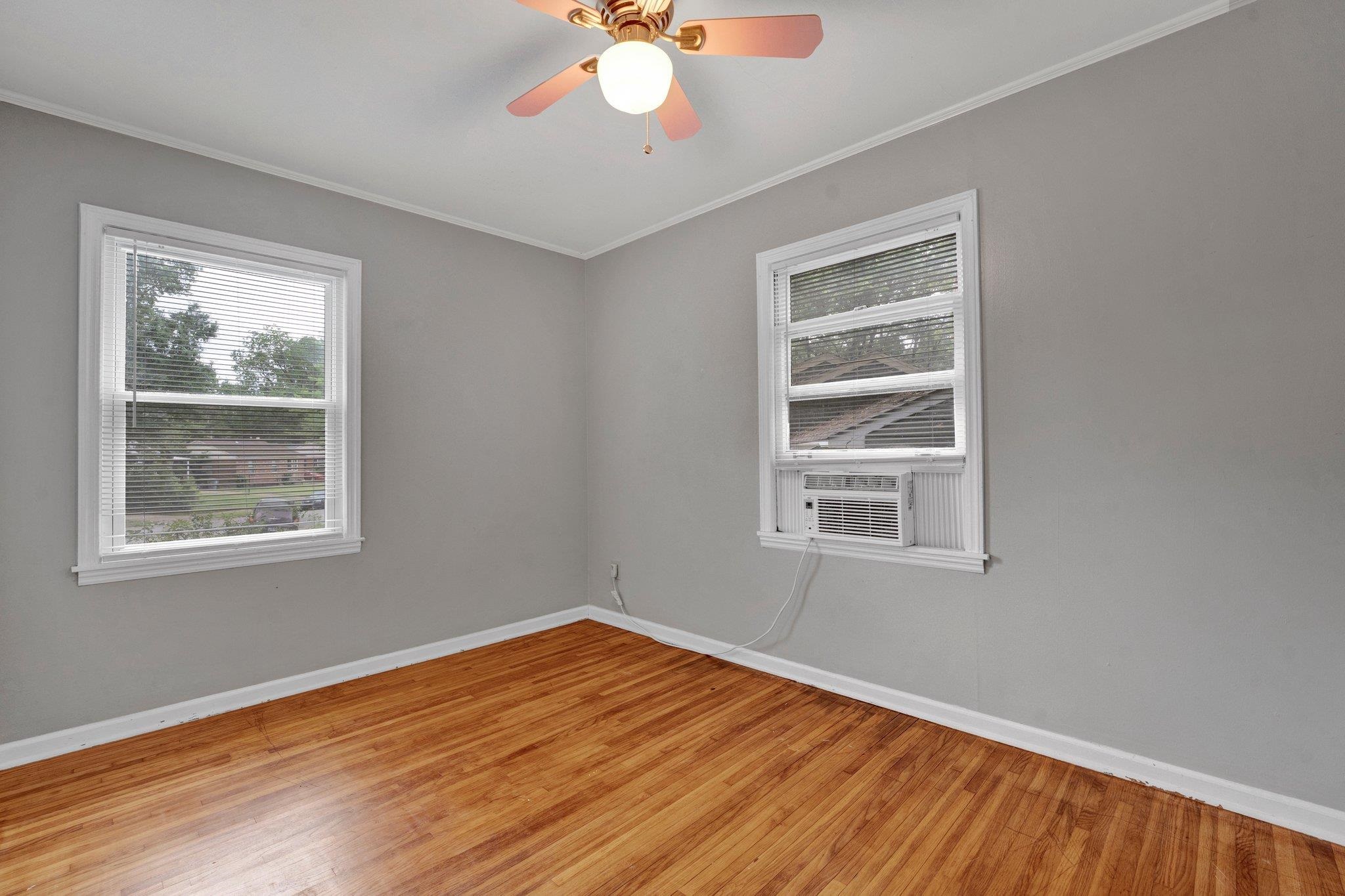 985 Wellsville Road Memphis, TN 38117 - Photo 9 of 24 a view of an empty room with wooden floor and a window