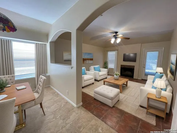 a living room with furniture and a fireplace