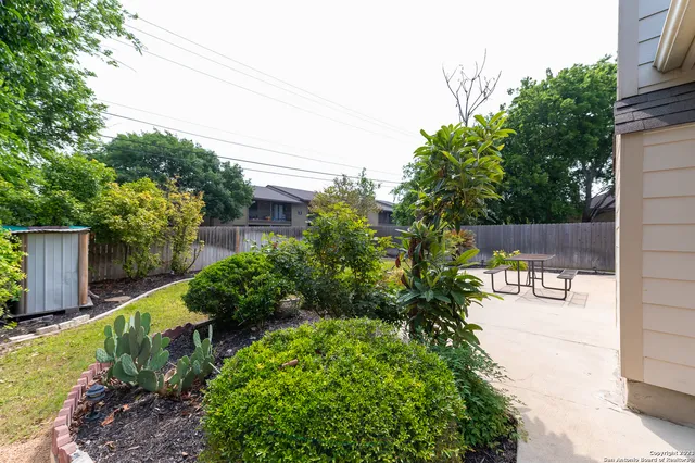 a front view of a house with a yard and outdoor seating