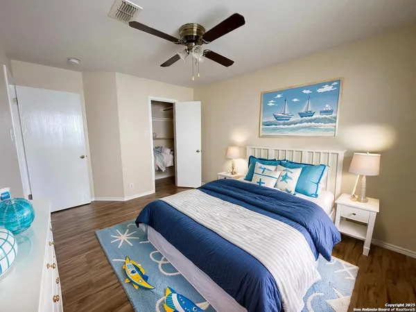 a bedroom with bed and wooden floor