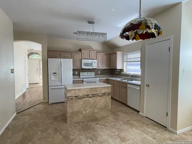 a kitchen with stainless steel appliances a refrigerator a sink and a stove