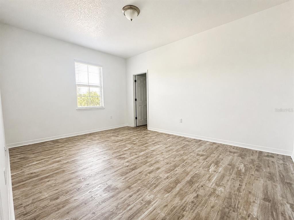 8531 Geddes Loop Orlando, FL 32836 - Photo 16 of 20 an empty room with wooden floor and windows