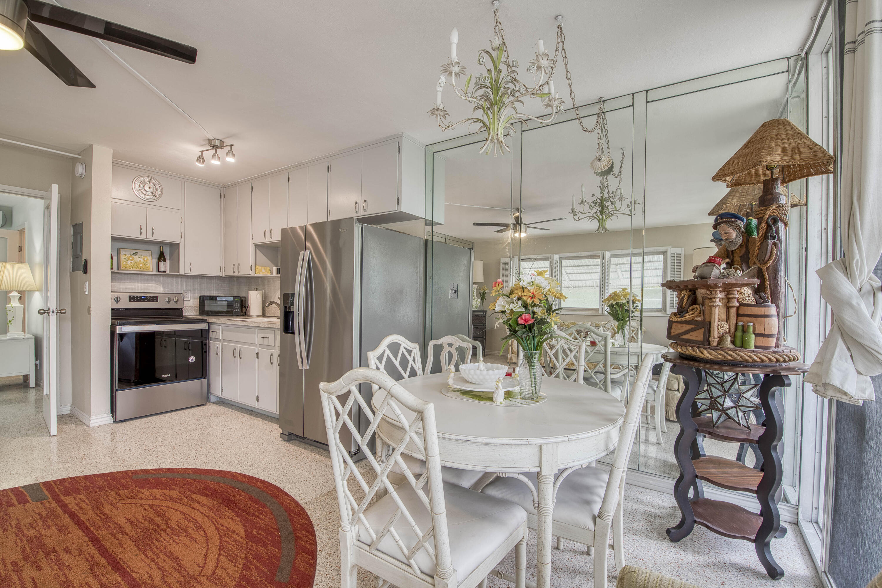 901 North Birch Road, Unit D10 Fort Lauderdale, FL 33304 - Photo 4 of 20 a kitchen with stainless steel appliances granite countertop a refrigerator a oven a sink a dining table and chairs with wooden floor