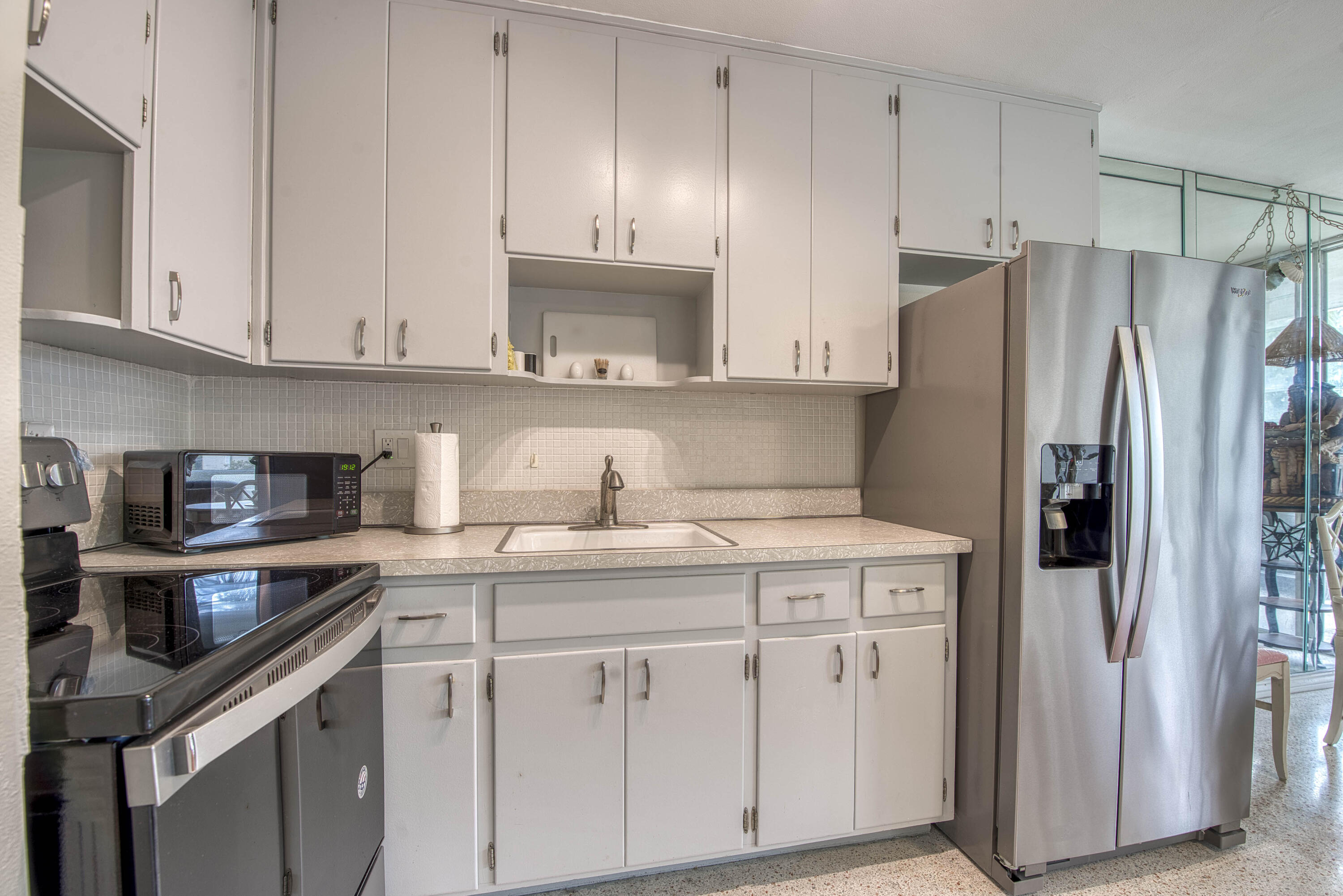 901 North Birch Road, Unit D10 Fort Lauderdale, FL 33304 - Photo 5 of 20 a kitchen with stainless steel appliances granite countertop a refrigerator and a stove