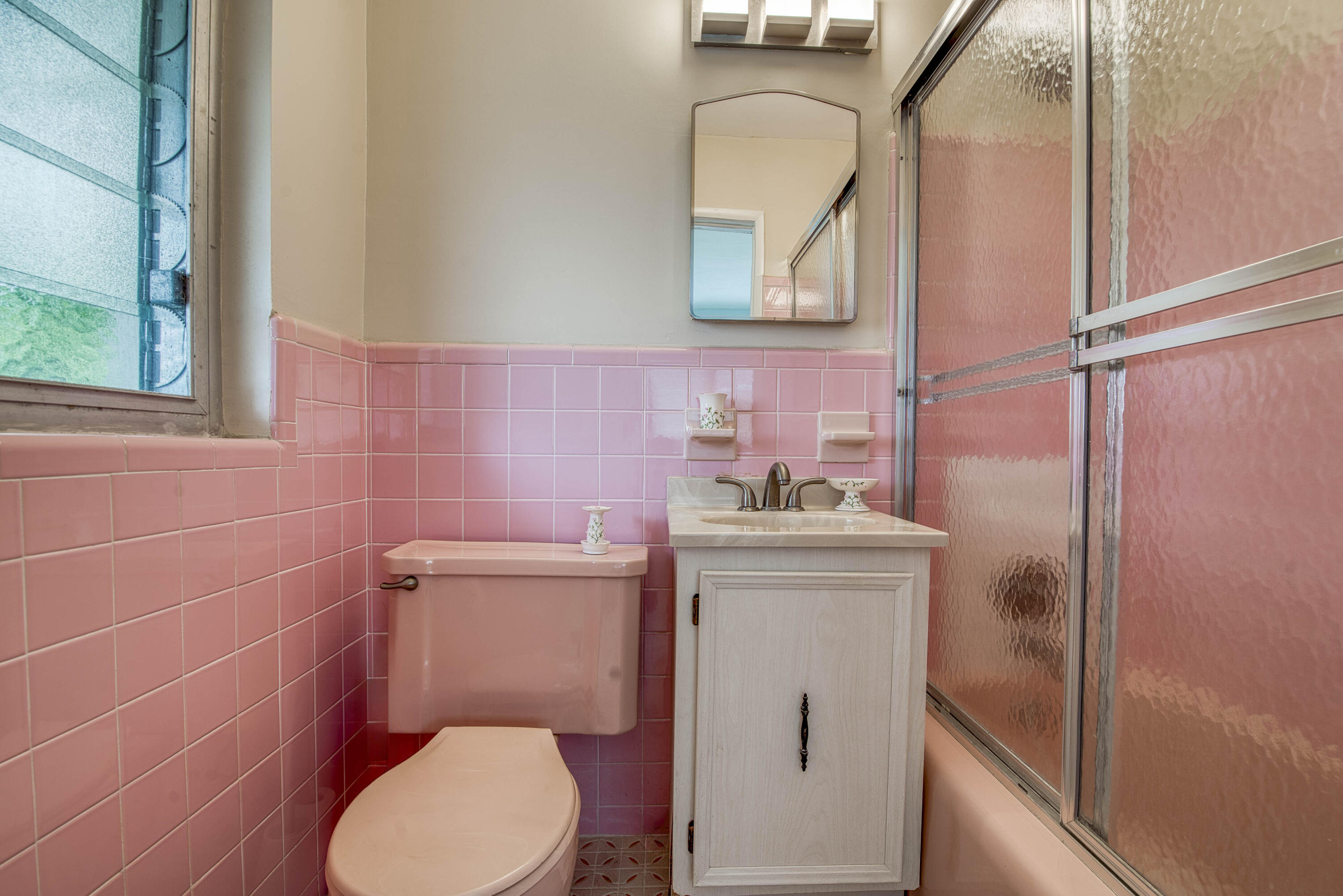 901 North Birch Road, Unit D10 Fort Lauderdale, FL 33304 - Photo 9 of 20 a bathroom with a toilet sink and mirror