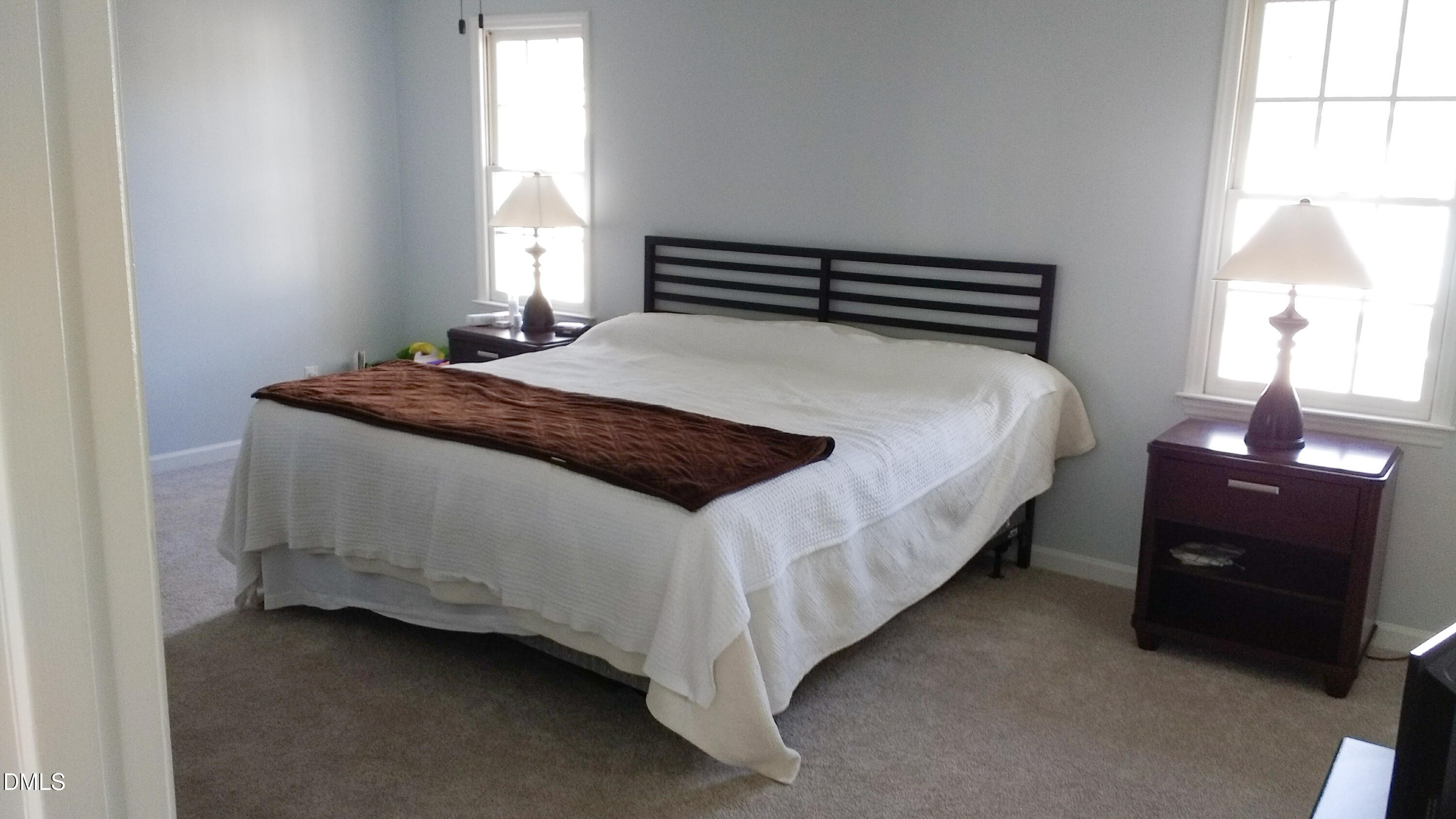 3109 Benton Circle Raleigh, NC 27615 - Photo 15 of 29 a bedroom with a bed and a lamp
