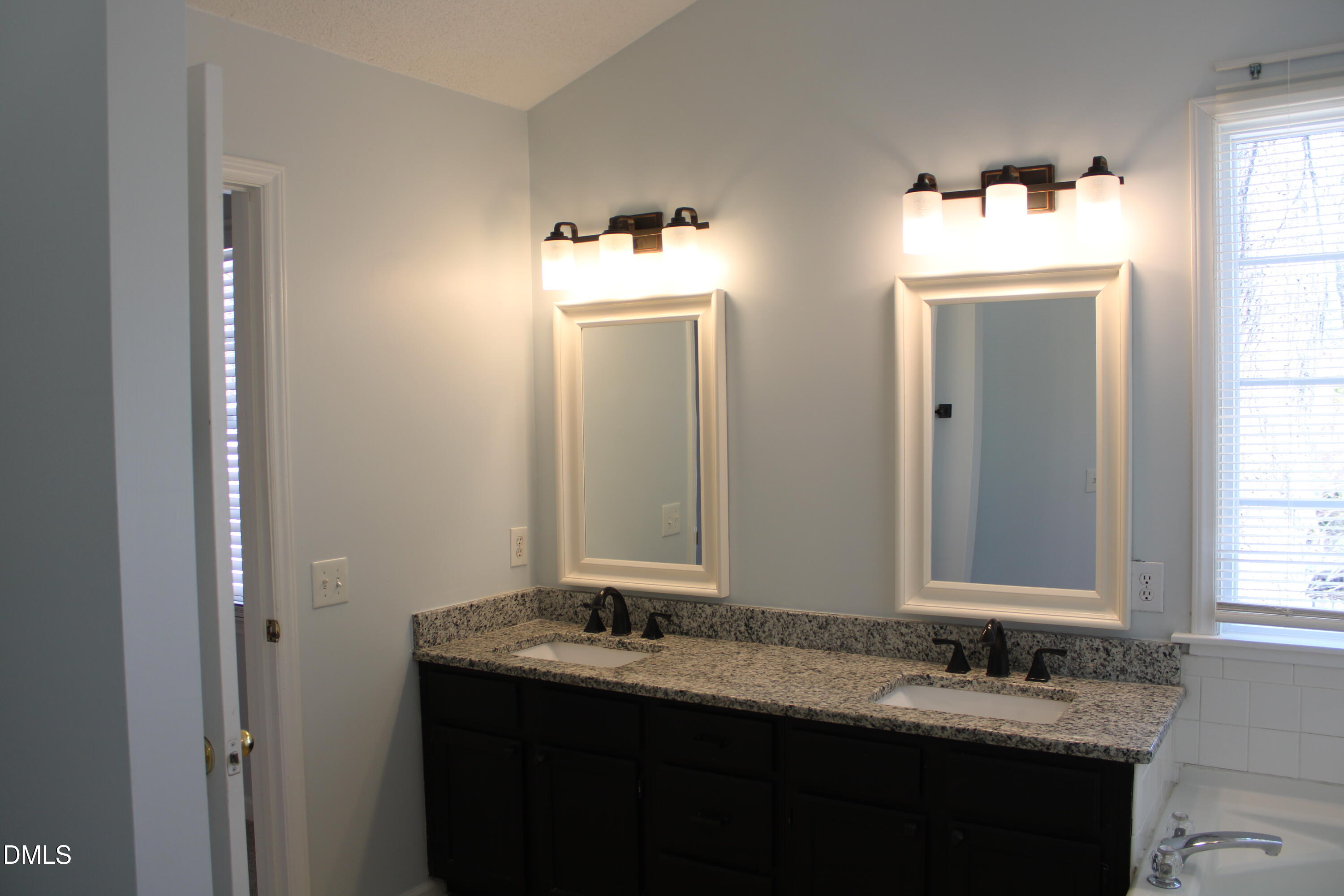 3109 Benton Circle Raleigh, NC 27615 - Photo 17 of 29 a bathroom with a double vanity sink and a mirror
