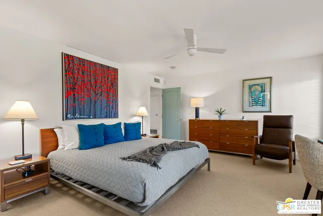 a bedroom with furniture and a lamp