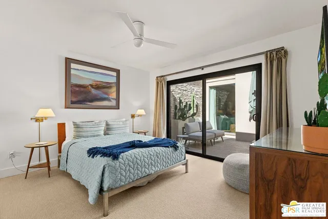 a bedroom with a bed and a large window