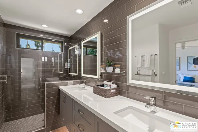a bathroom with a sink double vanity and a shower