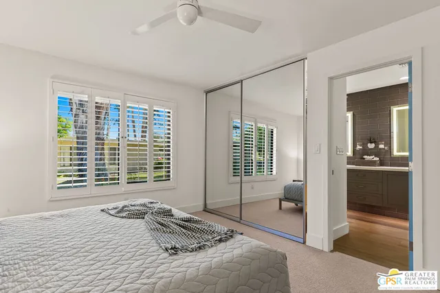 a bedroom with a bed and glass door