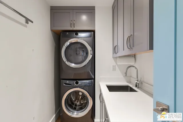 a utility room with sink dryer and washer
