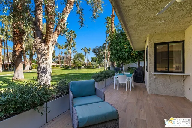 a view of a patio with couches table and chairs and potted plants