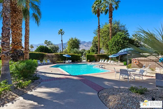 a view of a backyard with swimming pool